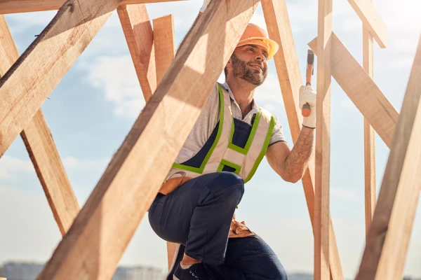 joyous construction site worker with hammer building