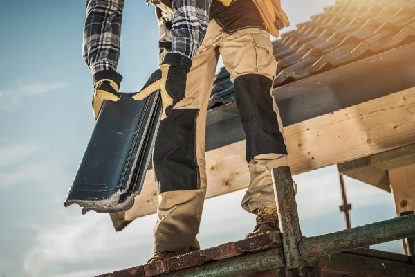 roofer with ceramic tiles in hand
