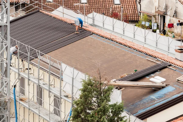 workers repairing a flat roof
